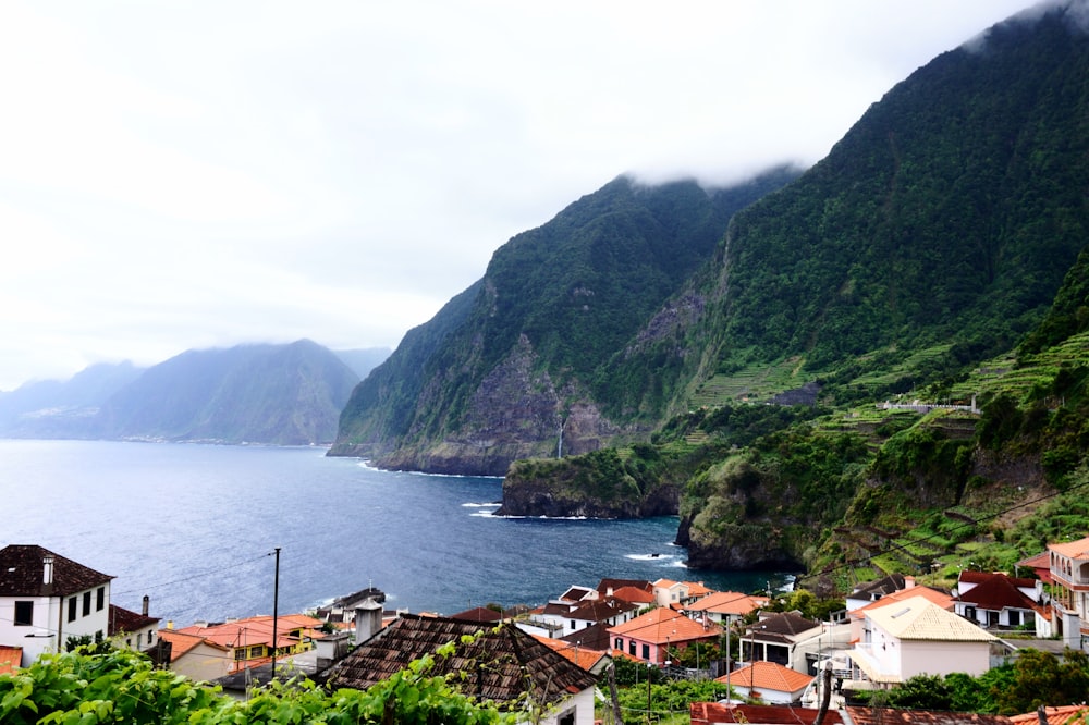 a scenic view of a village by the ocean