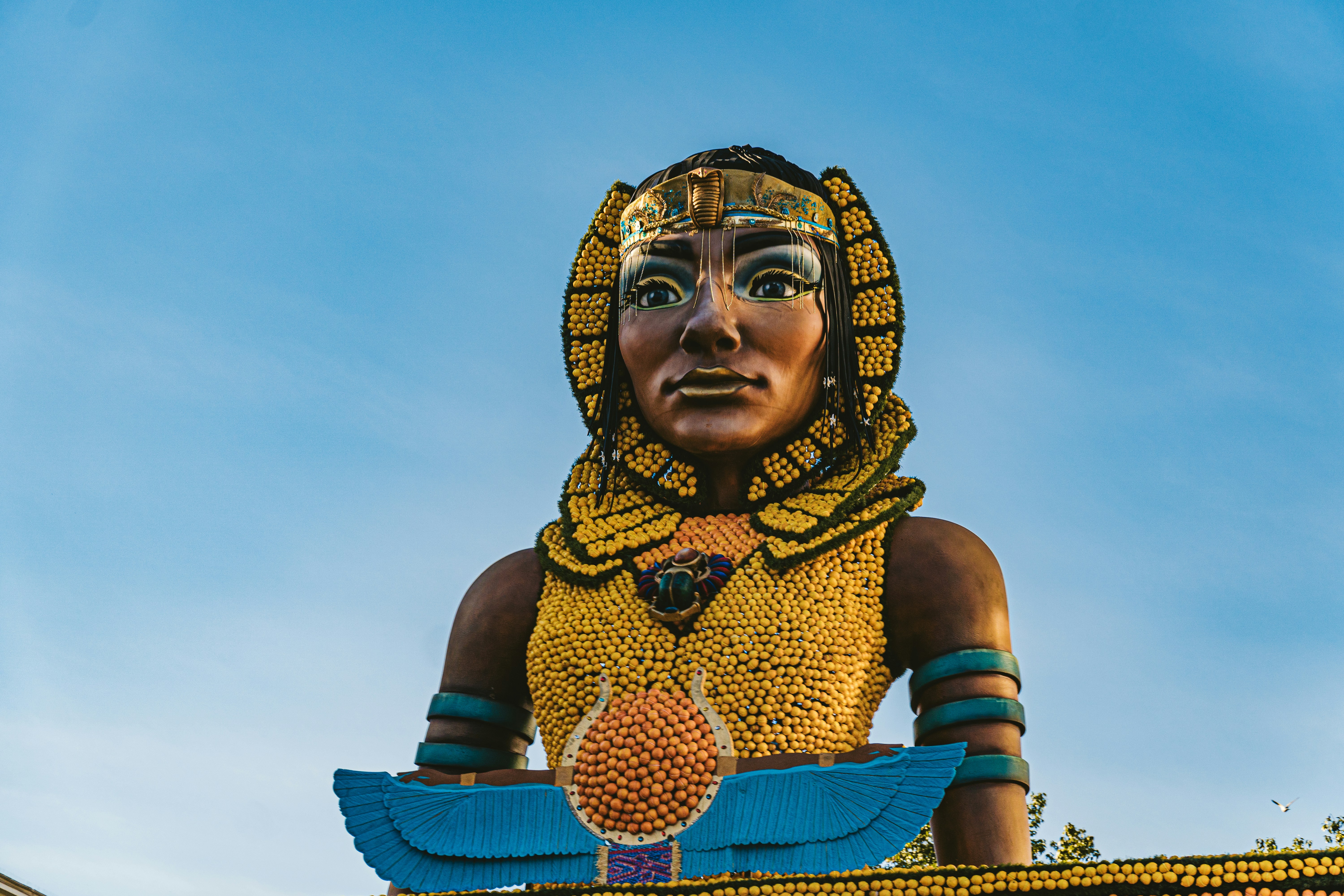 Artistic sculpture of a woman with a bird, highlighting public art and the surrounding nature.