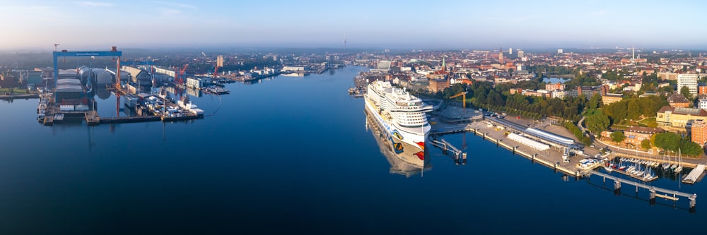 a cruise ship docked in a harbor next to a city