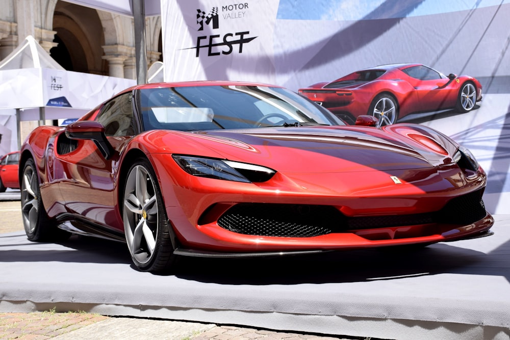 a red sports car driving down a street