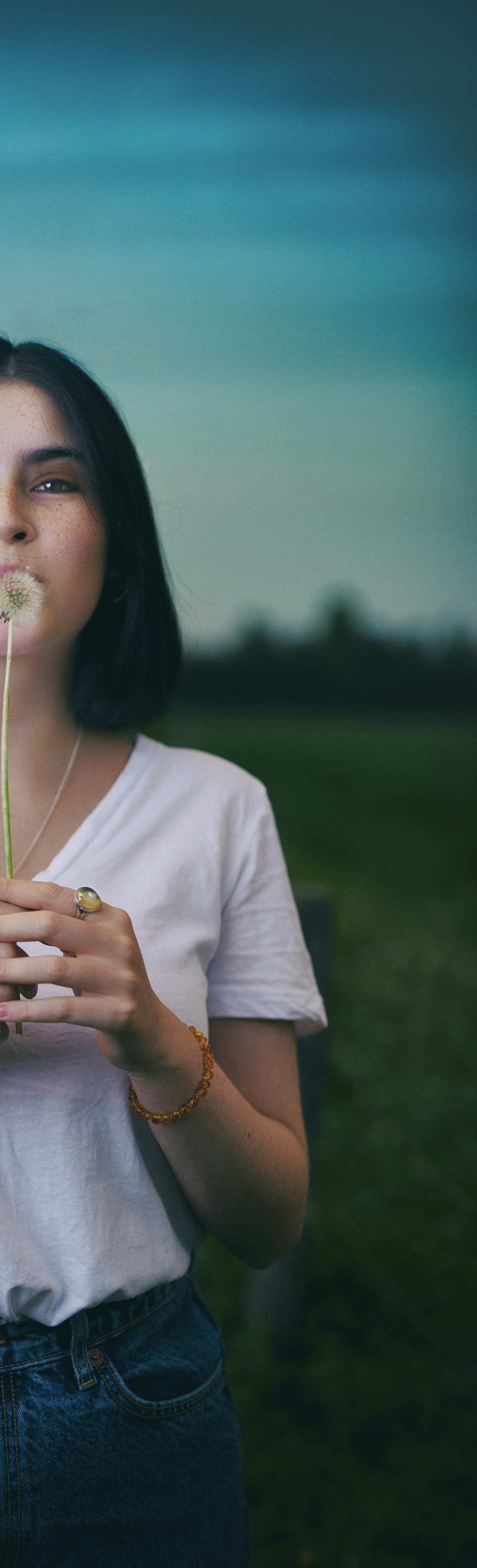 a woman holding a flower in her hands