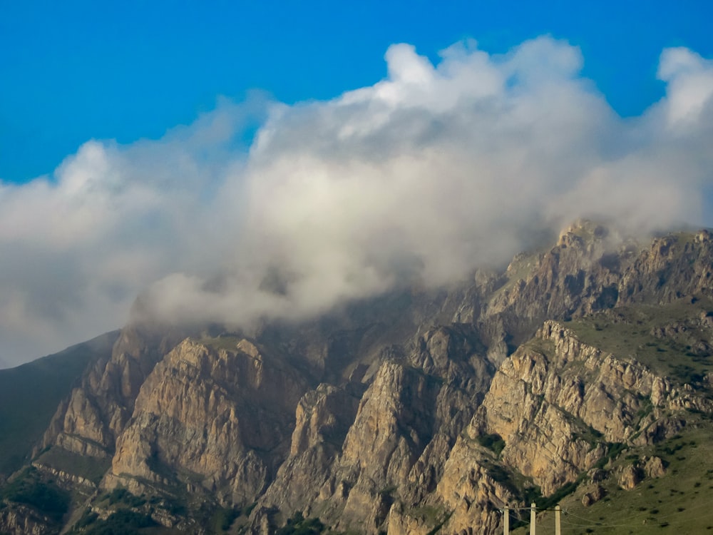 a mountain covered in a cloud filled sky