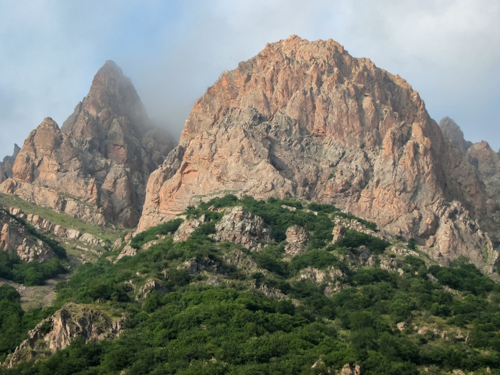 a mountain range with a few trees on the side