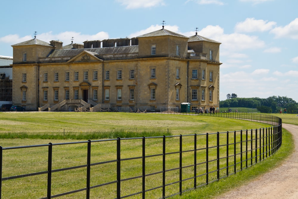 a large building with a fence in front of it