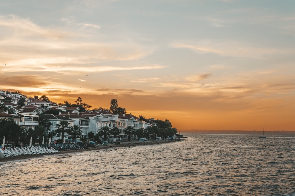 a sunset view of a row of houses along the water