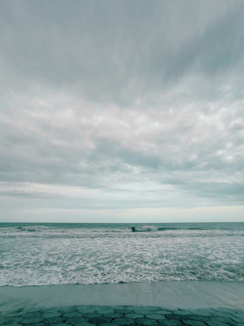 a person riding a surfboard on top of a wave