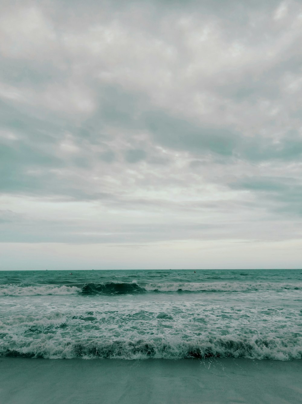 a beach with waves coming in to shore