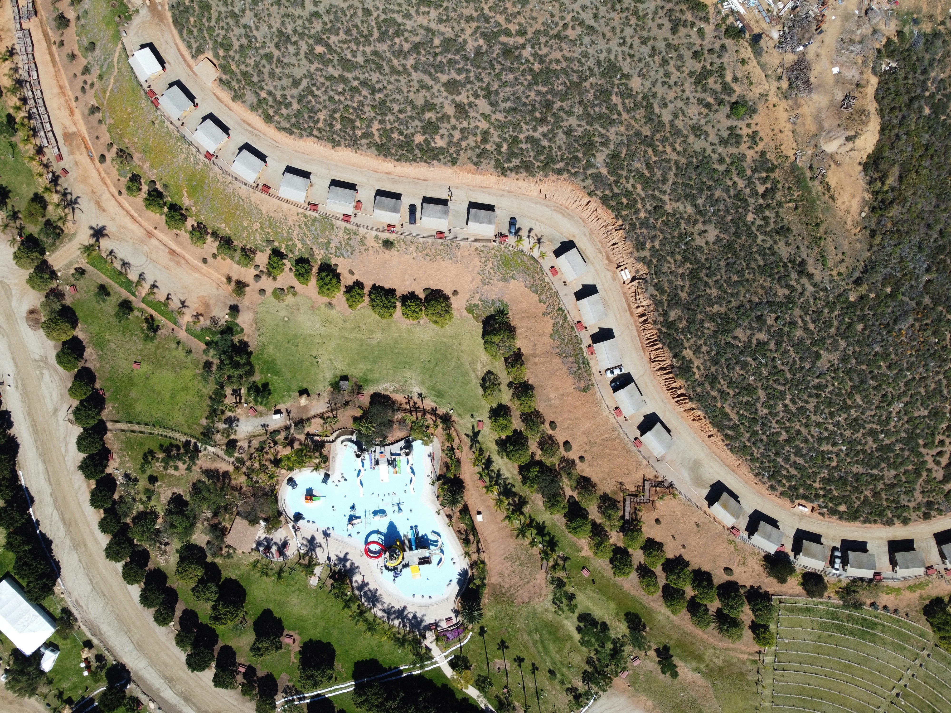 an aerial view of a park with a swimming pool