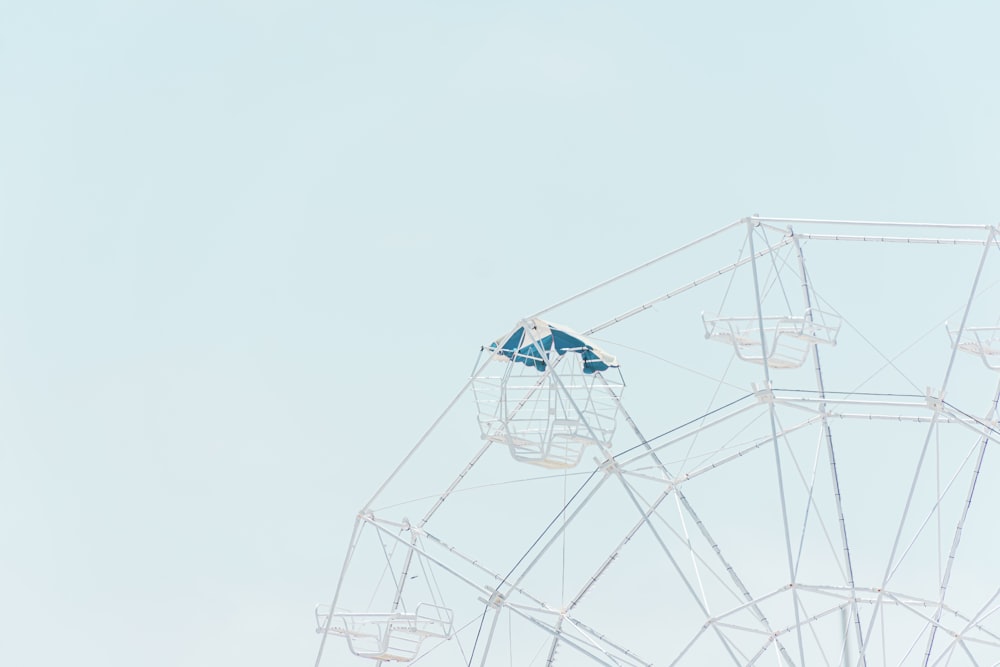 a ferris wheel with a blue umbrella on top