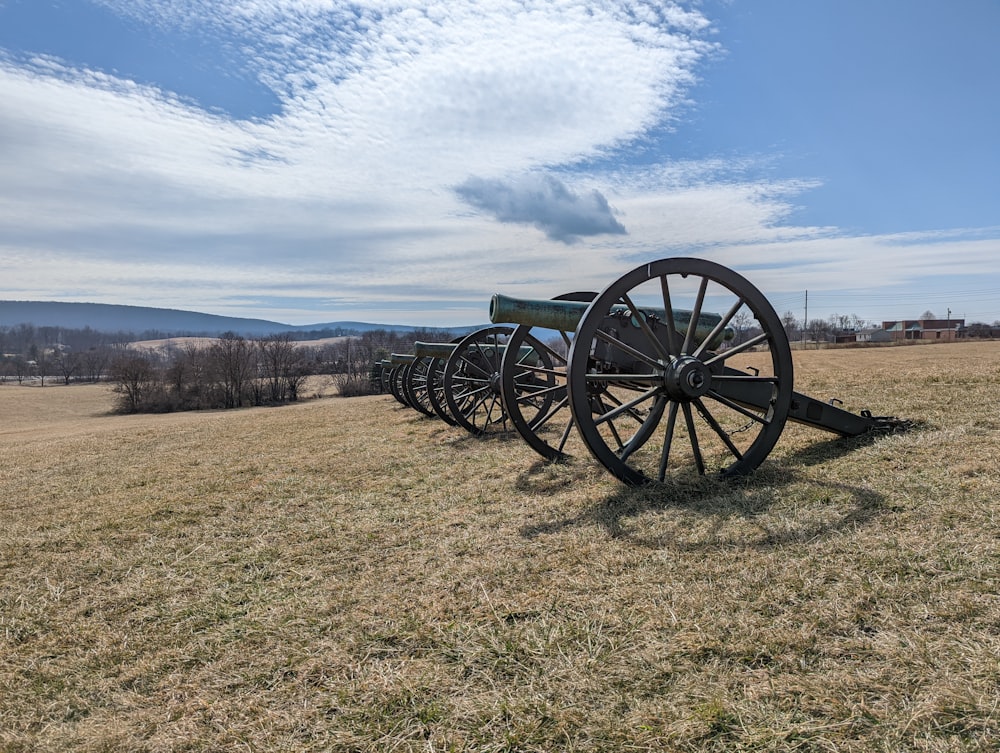 a row of civil war cannon on display in a field