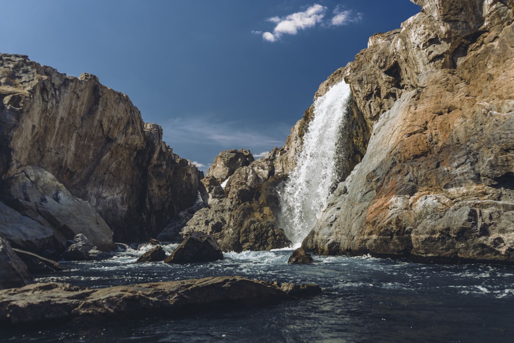 a large waterfall is coming out of the rocks