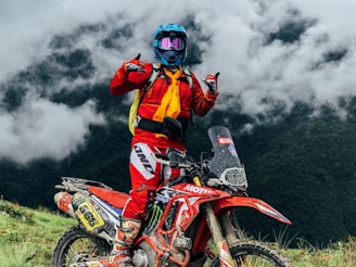 a person on a dirt bike giving a thumbs up