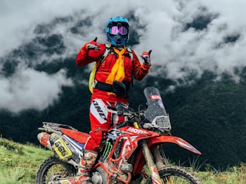 a person on a dirt bike giving a thumbs up