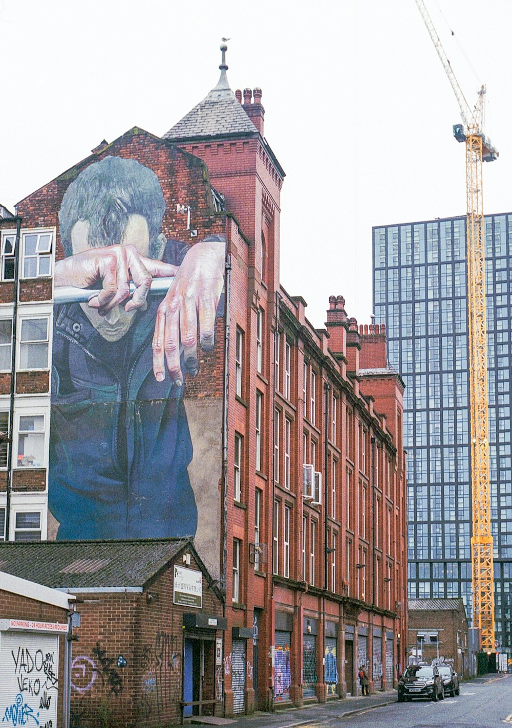 a large mural of a man smoking a cigarette on the side of a building