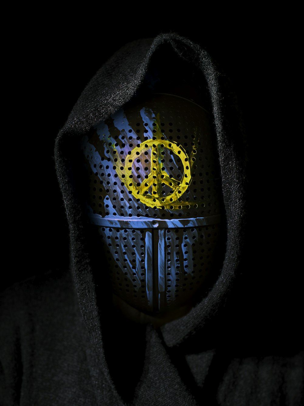 a person wearing a hoodie with the word peace painted on it