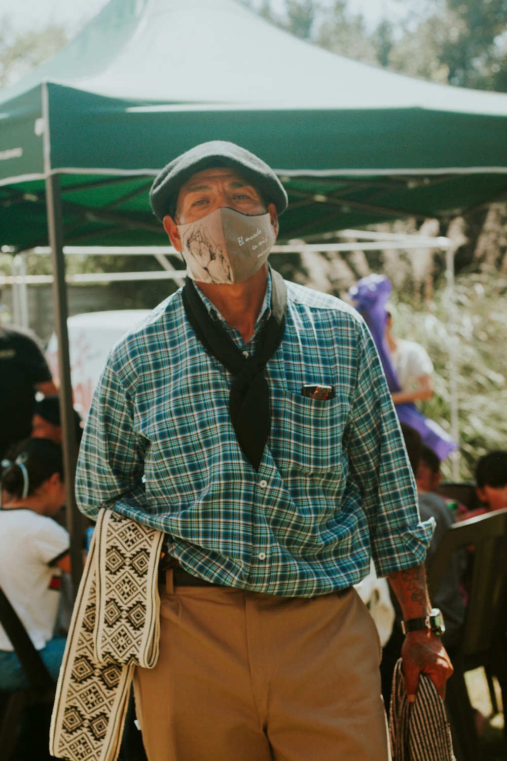 a man wearing a face mask and holding a tennis racquet