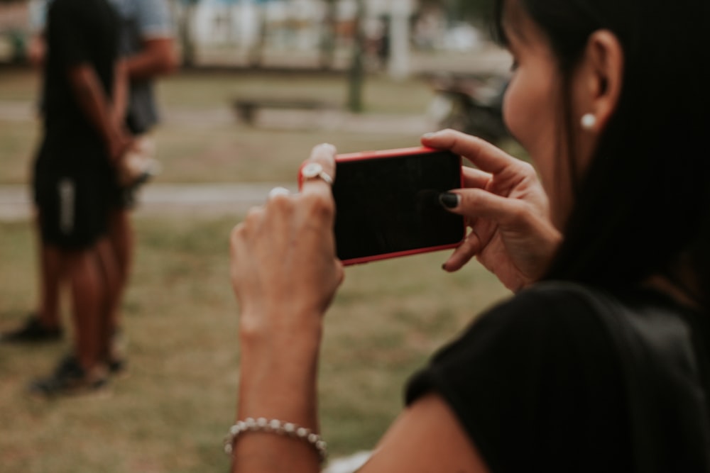 a woman taking a picture with her cell phone