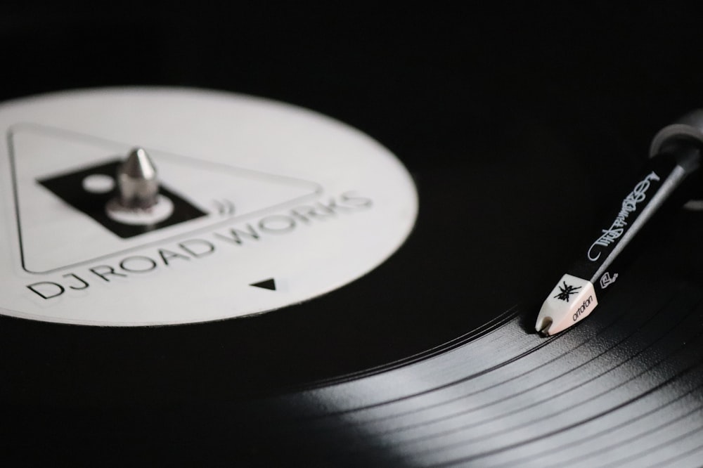 a record player with a pen on top of it