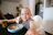 A smiling toddler sitting happily at a high chair enjoying a healthy meal.
