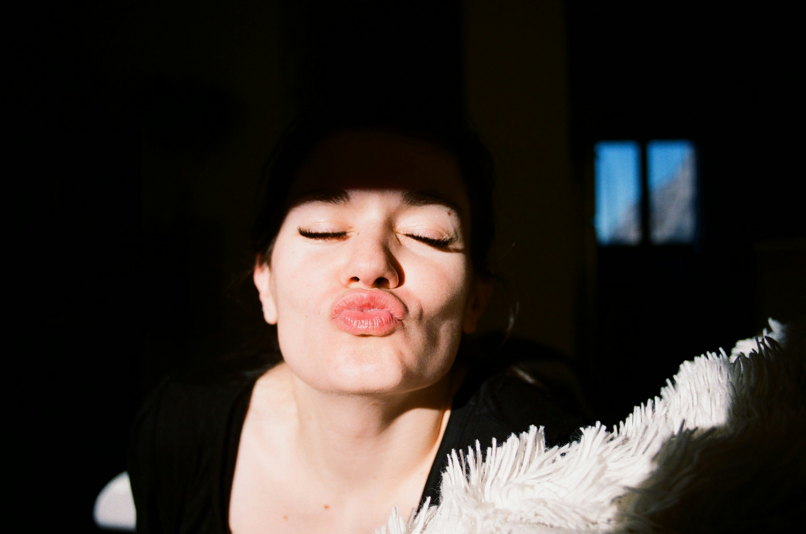 a woman with her eyes closed and her eyes closed