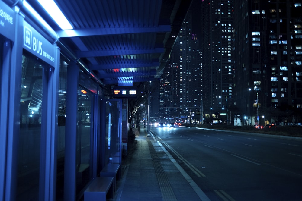 a city street at night with buildings lit up