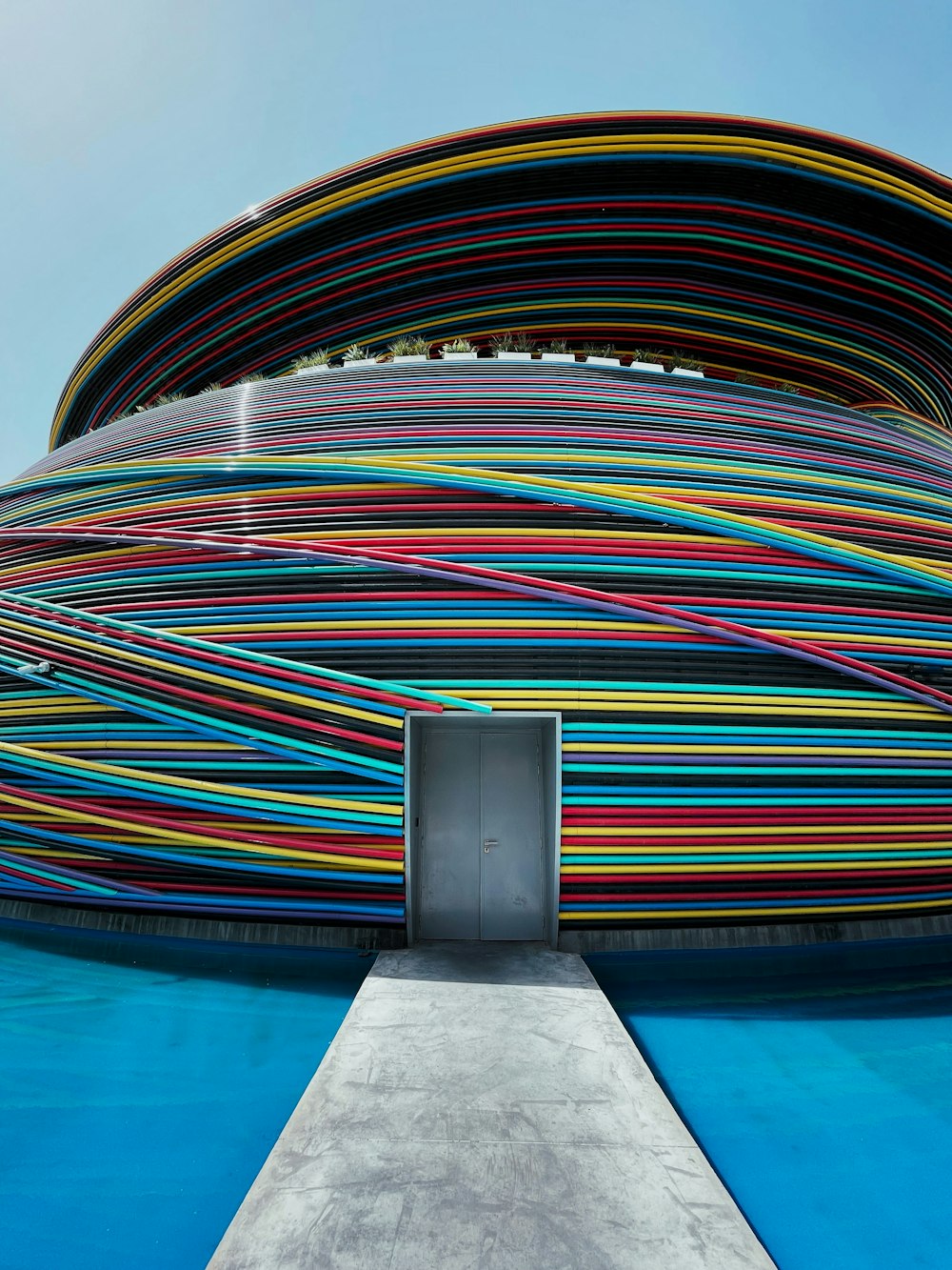 a very colorful building with a door in the middle of it