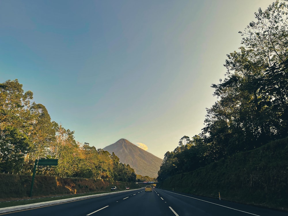 a view of a road with a mountain in the background