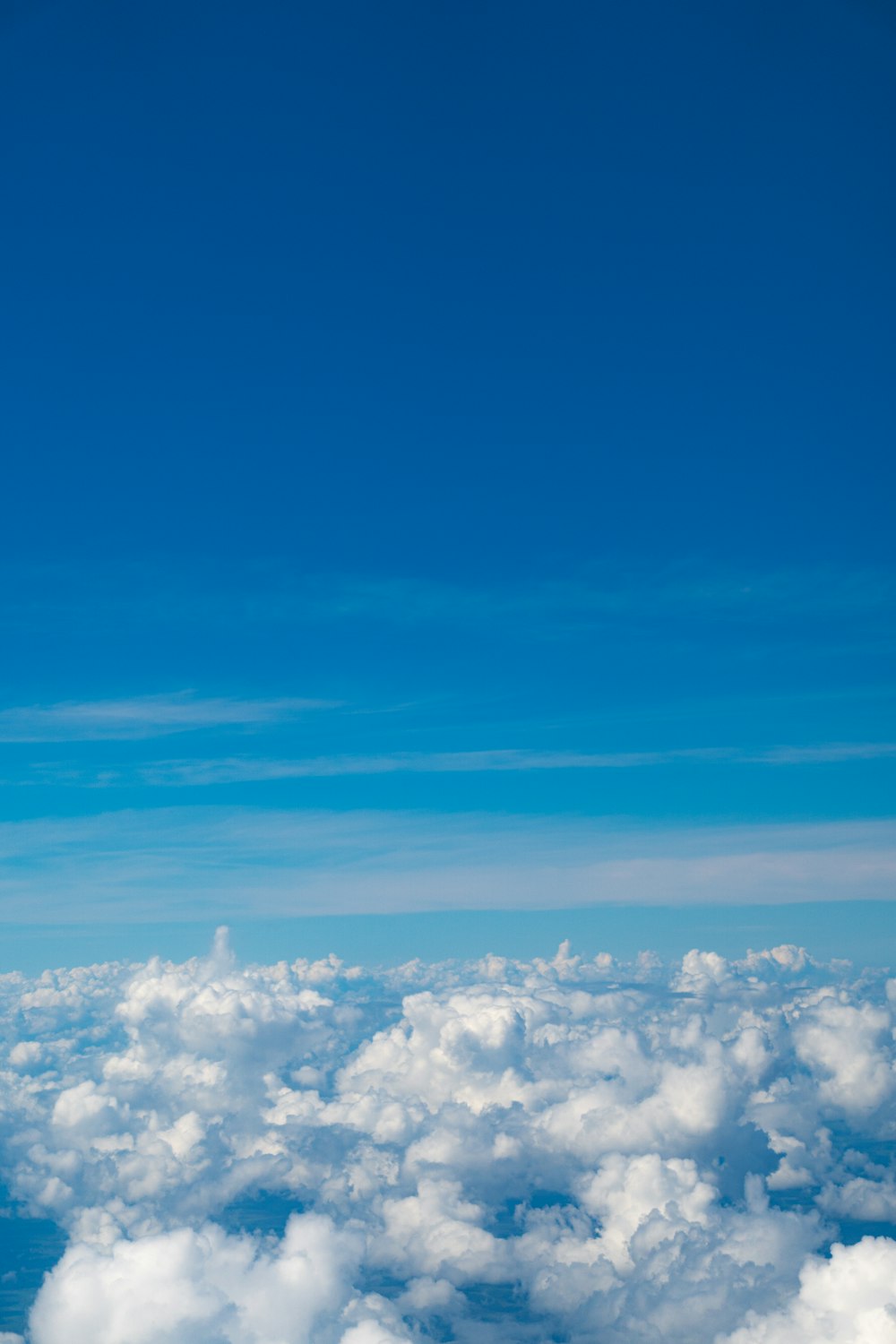 an airplane flying high above the clouds in the sky