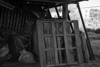 a black and white photo of a pile of wood