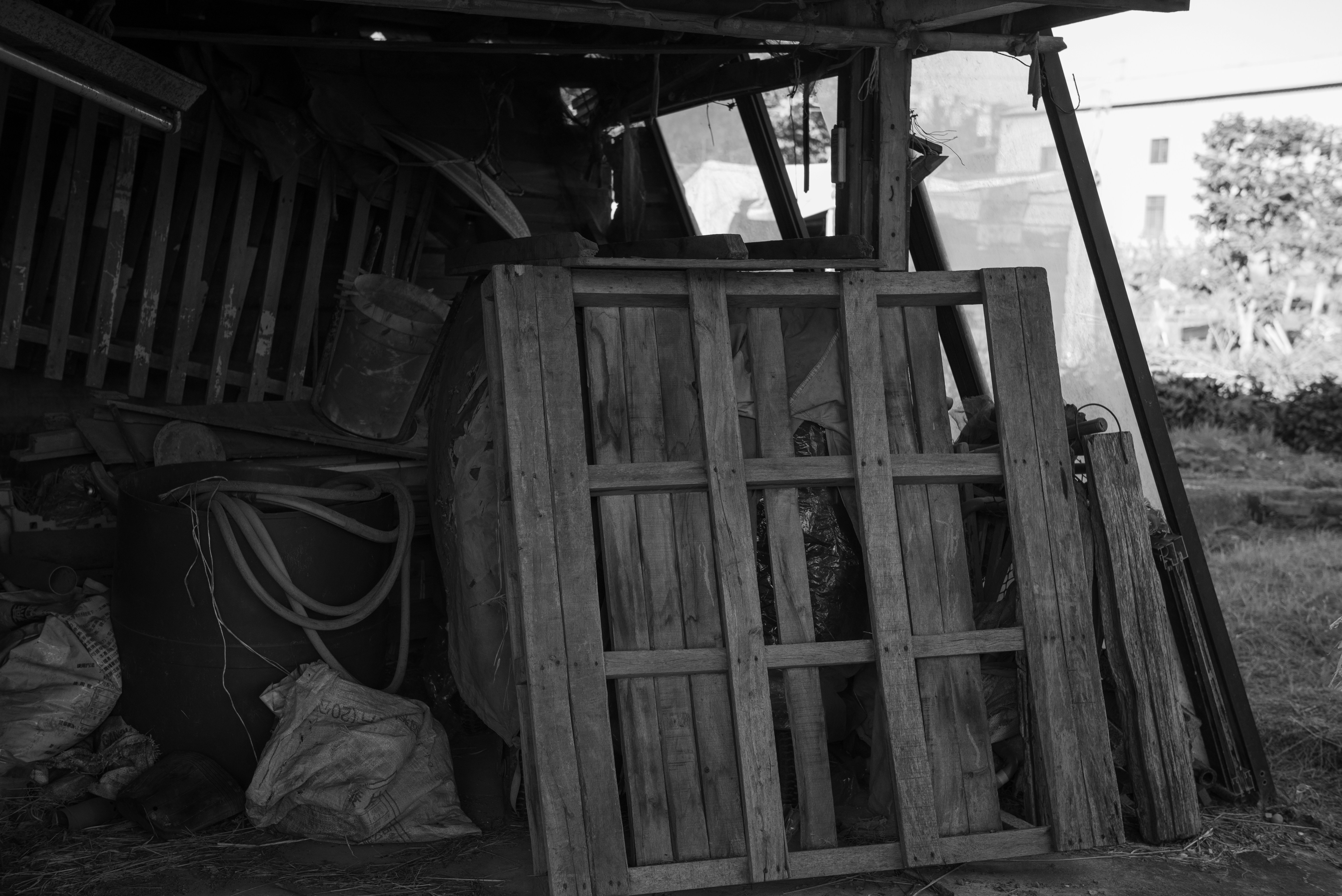 a black and white photo of a pile of wood
