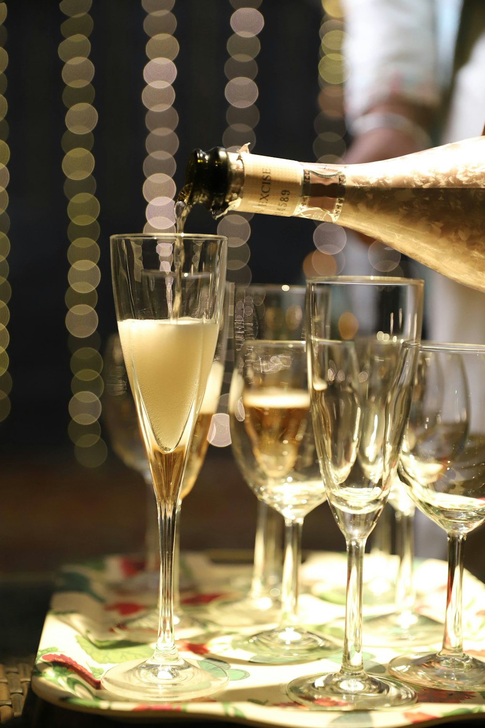 a bottle of champagne being poured into wine glasses