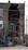 A brick building has suffered significant structural damage, with a large section of the wall missing, exposing its interior. The area around the building is cluttered with debris, including bricks and various wooden boards. Electrical wires are hanging across the scene.