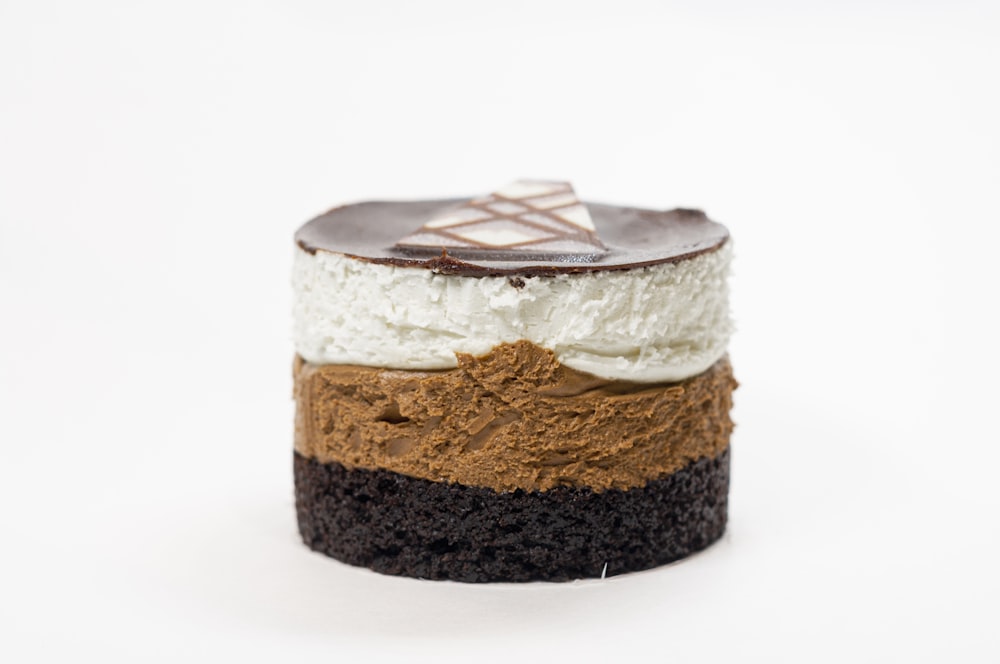 a piece of cake with chocolate and cream on top
