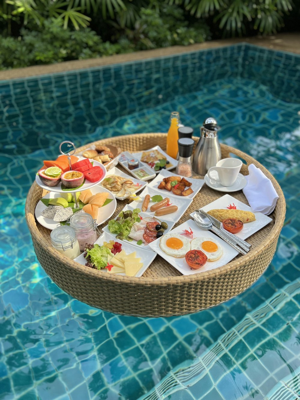a tray of food sitting on top of a swimming pool