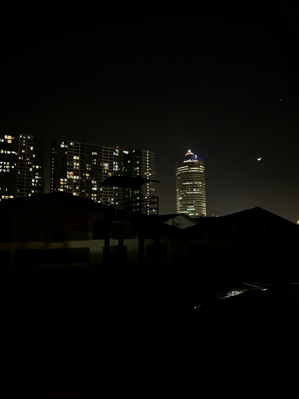 a city skyline at night with skyscrapers lit up