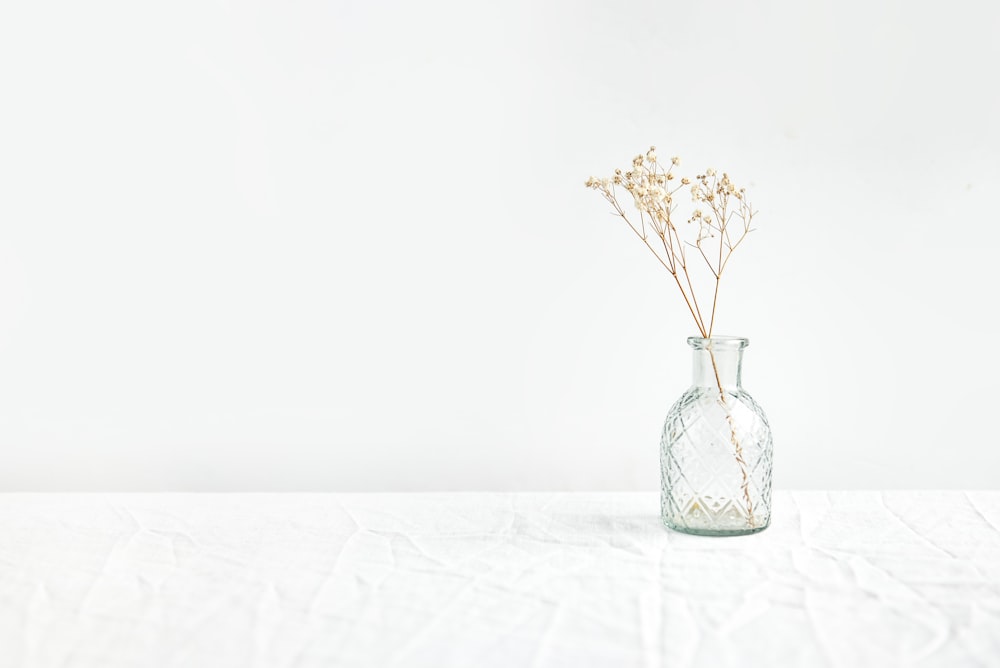 a vase with some flowers in it on a table