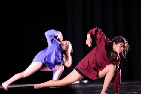 a couple of women standing on top of a stage