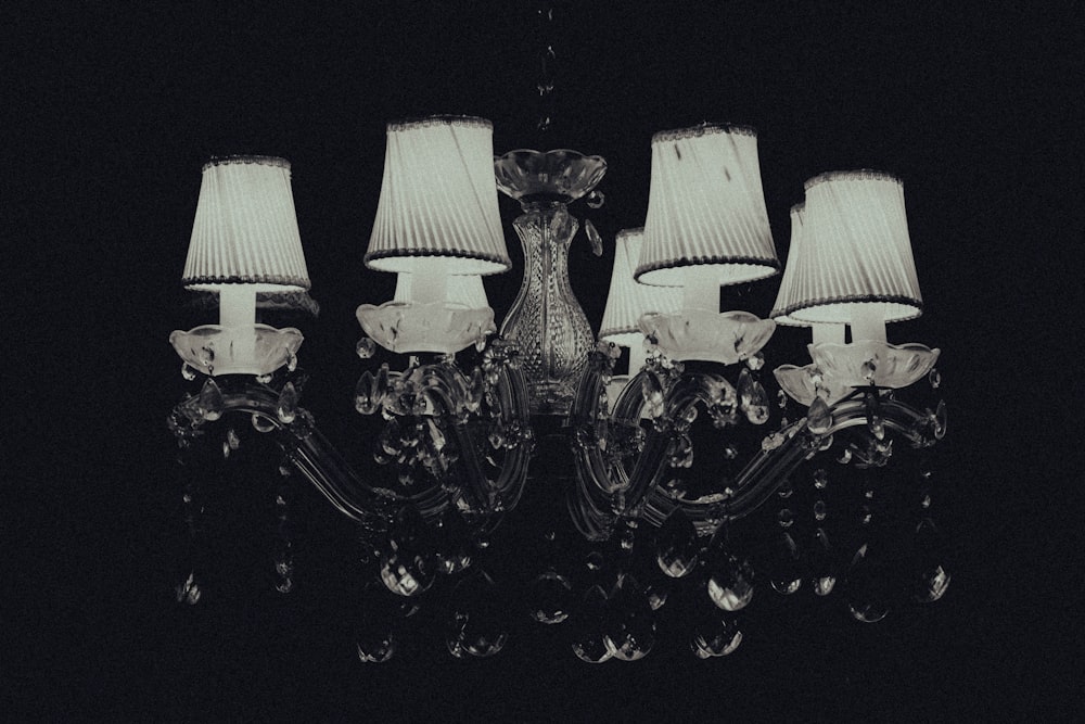 a chandelier with four lamps on it