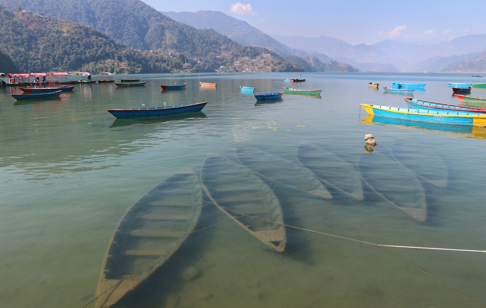 a group of boats floating on top of a lake