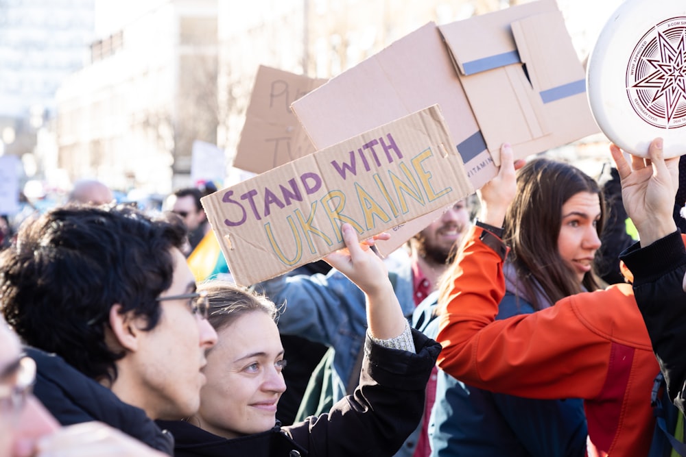 a group of people holding up signs and signs