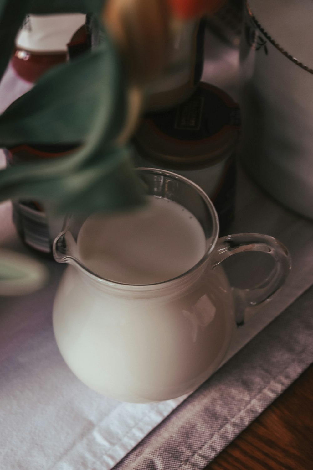 a pitcher of milk sitting on top of a table