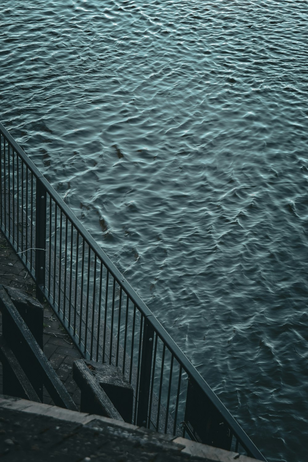 a person walking up a set of stairs next to a body of water