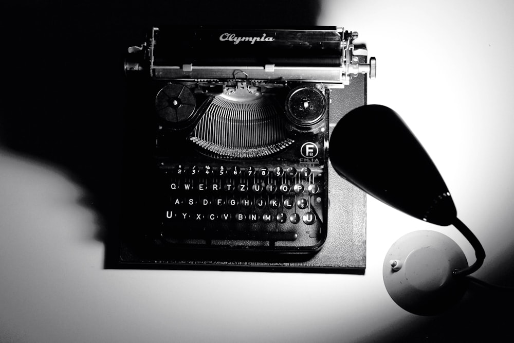 a black and white photo of an old fashioned typewriter