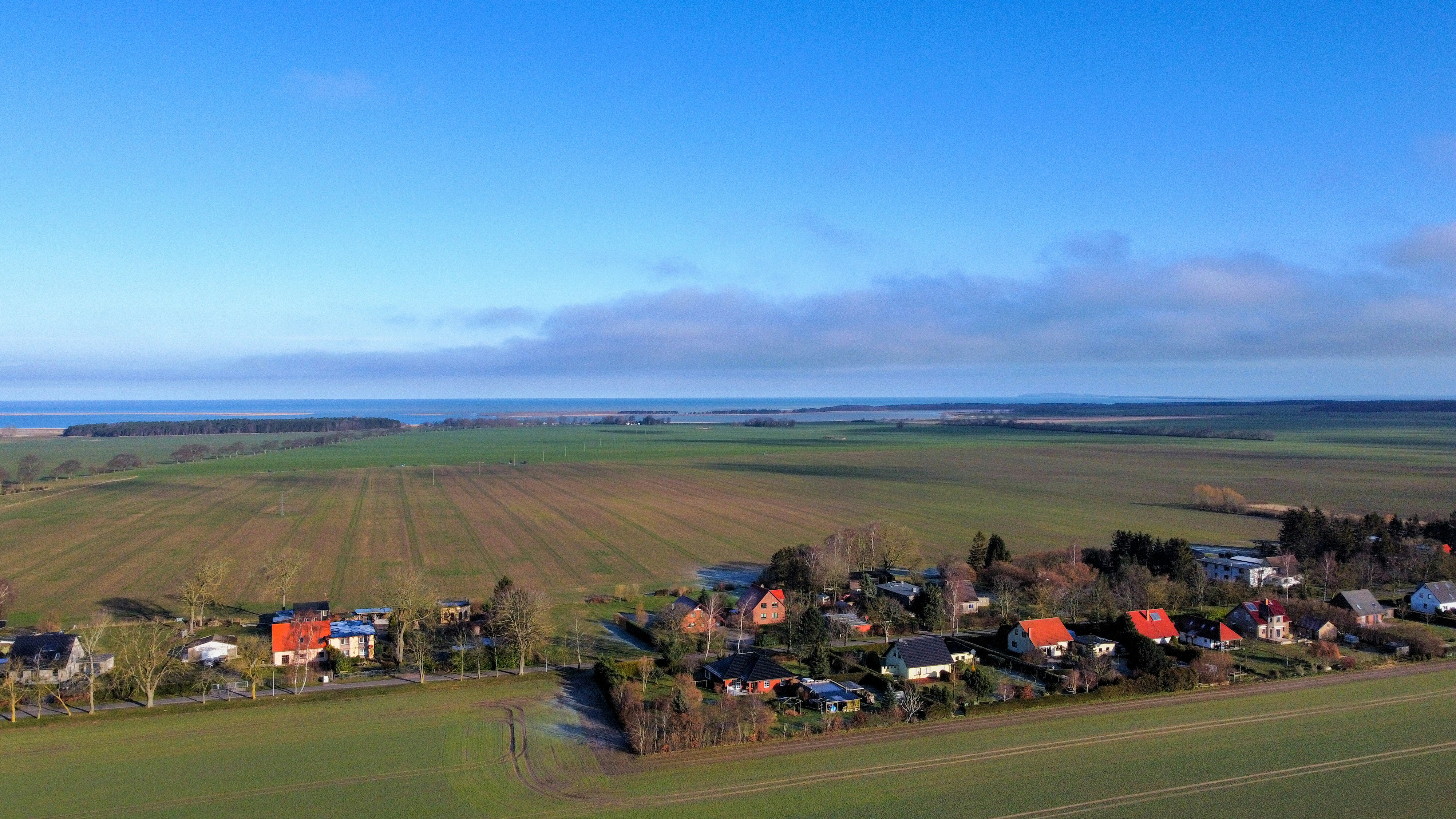 an aerial view of a rural area with houses and fields