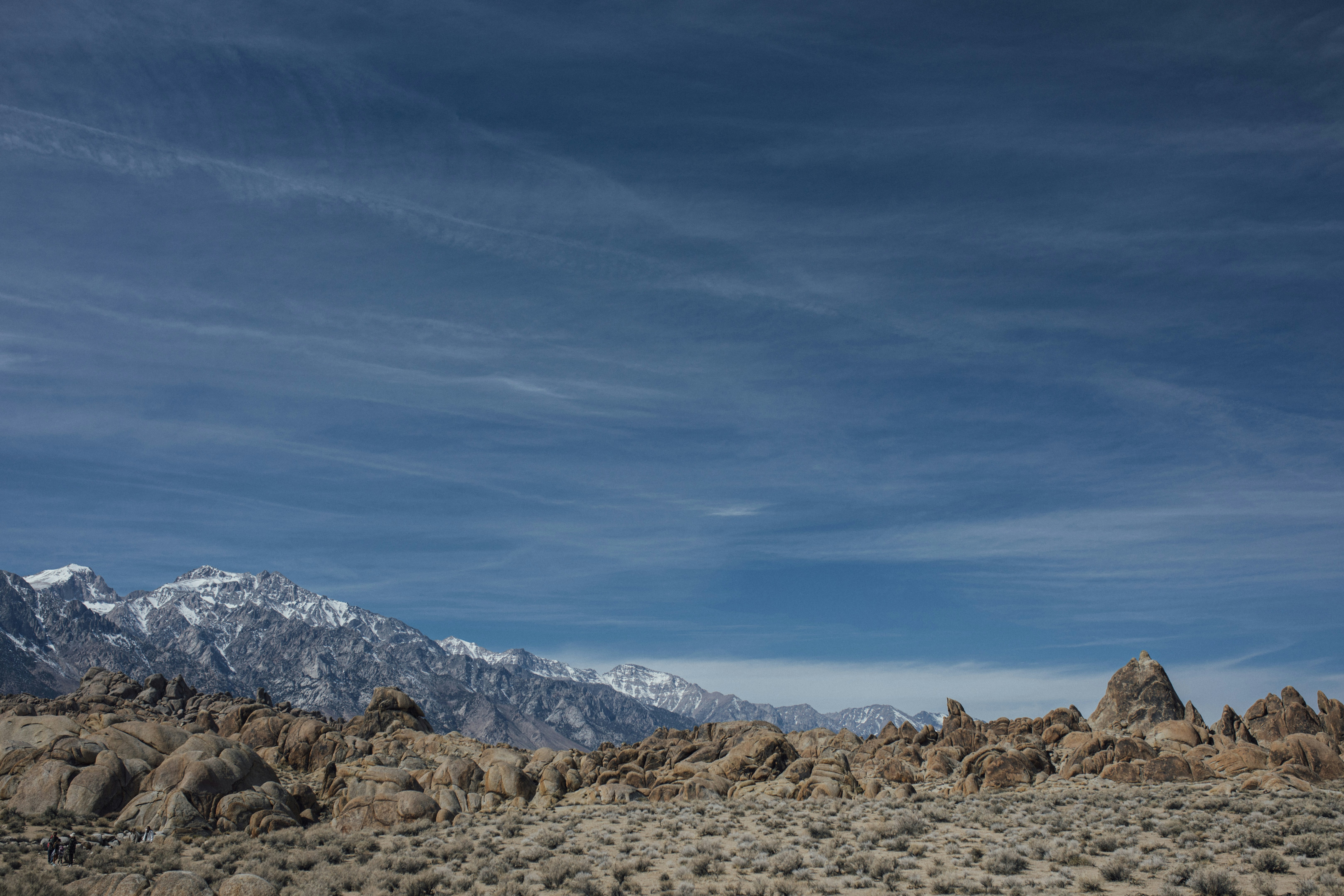 a rocky landscape with mountains in the background, 