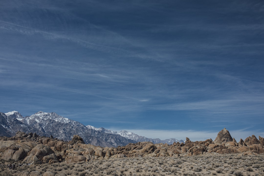 a rocky landscape with mountains in the background,