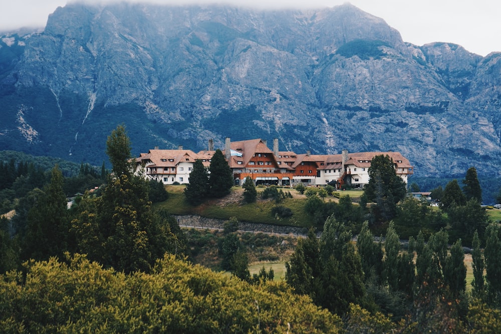 a large house sitting on top of a lush green hillside