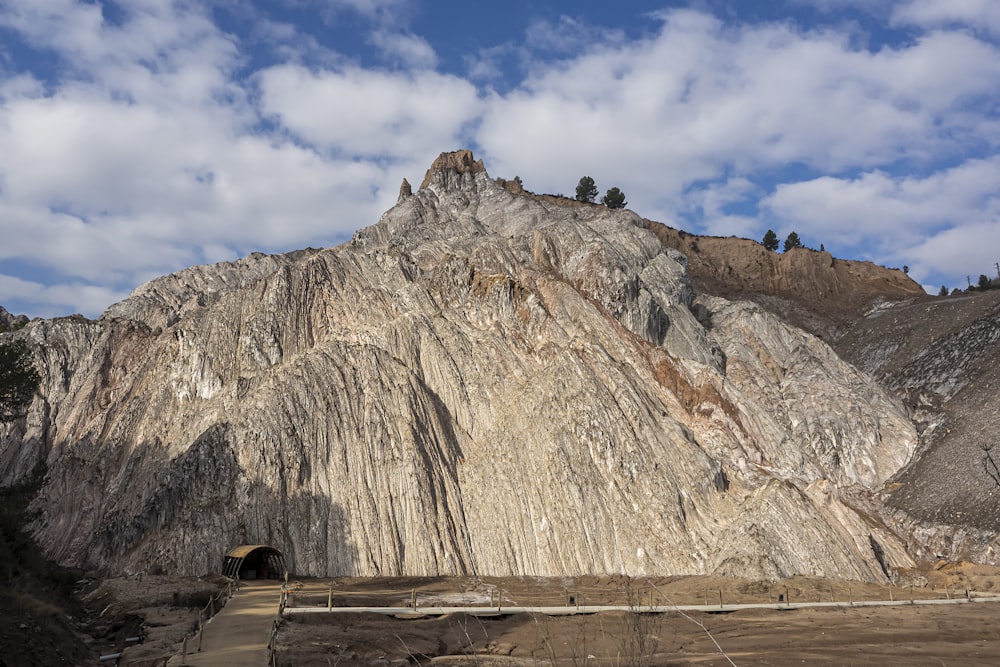 a large rock formation with a sky background