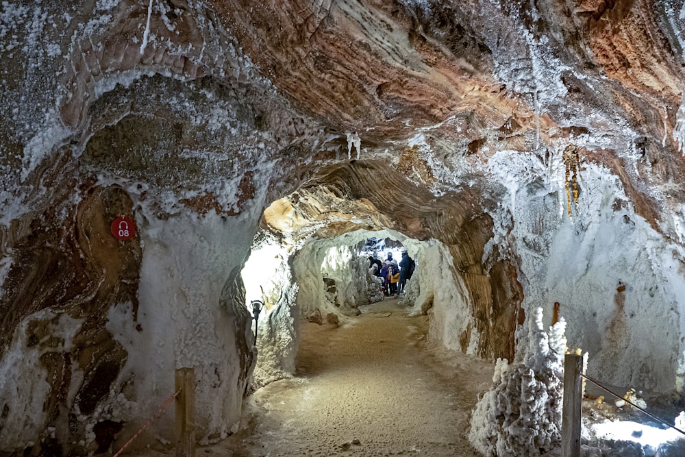 a long narrow tunnel with people walking through it