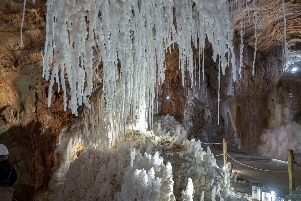 a cave filled with ice and icicles hanging from the ceiling
